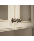 Aspen Round Cabinet Knob In Light Bronze Finish, One And One Eighth Inch Diameter, Seven Eighths Inch Projection on cabinet doors