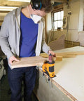 Person using Heavy Duty 650W Portable Oscillating Spindle Sander With Variable 1800 To 3200 RPM Speed for woodworking.