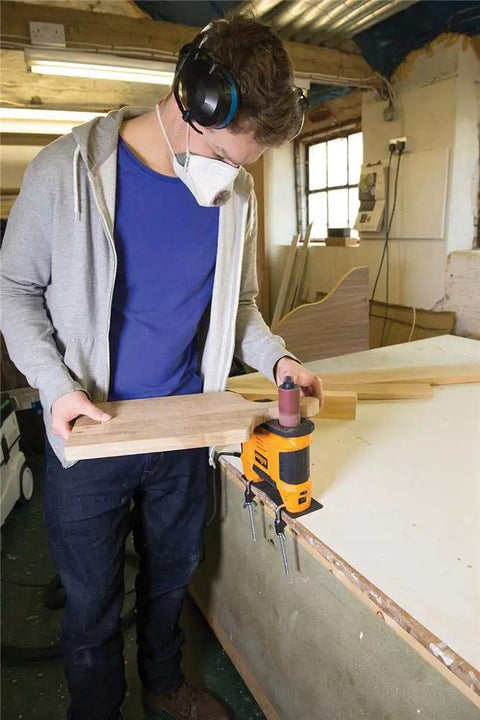 Person using Heavy Duty 650W Portable Oscillating Spindle Sander With Variable 1800 To 3200 RPM Speed for woodworking.