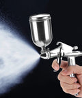 Compact Pneumatic Spray Gun With Tight 0.5mm Nozzle And 125ml Gravity Cup delivers atomization while spraying a fine mist.