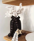 Straight Up Charred Aging Wood Stain For Interior Projects on black vase with white floral arrangement.