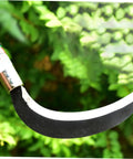 Close-up of Two Piece Manganese Steel Weeding Sickle Ergonomic Short Handle Garden Tool Set blade in greenery