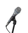 BETA 87A Studio Grade Vocal Microphone With Built In Pop Filter on a stand, showcasing supercardioid condenser design for live gigs.