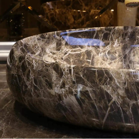 Slick Ceramic Oval Vessel Sink For Countertop Installation with a glossy finish and elegant marbled design.