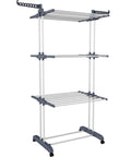 Top Shelf Oversized Four Tier Clothes Drying Rack With A Built Tough Foldable Frame Plus Side Wings For Hanging Laundry Towels Shoes And Quilts Roomy Air Drying Setup, freestanding with wheels.