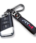 Clean Genuine Leather Car Key Ring For GMC AT4 Ride Durable Zinc Alloy Black Metal Fob Holder close-up with key fob and clip.