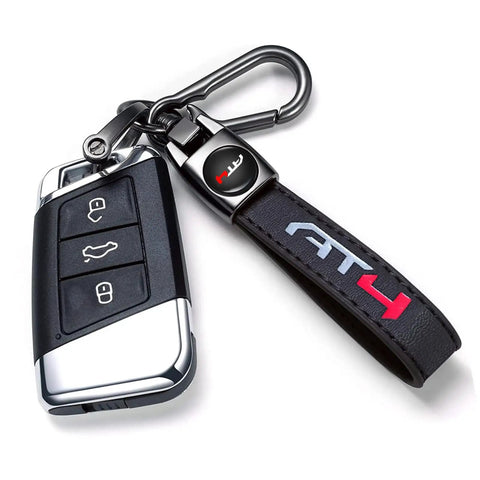 Clean Genuine Leather Car Key Ring For GMC AT4 Ride Durable Zinc Alloy Black Metal Fob Holder close-up with key fob and clip.