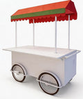 Hustle Made Easy With This Heavy Duty Outdoor Vending Cart, Weatherproof Canopy Design, Smooth Ride Wheels, Huge Prep Counter, And Eye Catching Stage Setup For Your Small Business Side Hustle - white mobile cart with red and green canopy.