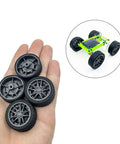 Hand holding 10 Pcs 30mm Rubber Wheels With Metal Shafts Round Axles For RC Cars Trucks Robots DIY Model Toy Wheels Replacement Accessories 2mm Shafts 100mm Length Set