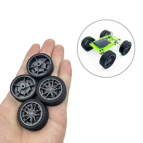 Hand holding 10 Pcs 30mm Rubber Wheels With Metal Shafts Round Axles For RC Cars Trucks Robots DIY Model Toy Wheels Replacement Accessories 2mm Shafts 100mm Length Set