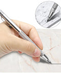 Top Tier Two Pack Tungsten Carbide Scribe Pens With A Freaking Strong Magnet And Steel Rule Including Ten Spare Tips For Quick Layouts And No Drama Metal Marking On Job Sites Everywhere, hand using pen on marble.