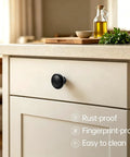 Slick Matte Black Cabinet Knobs Heavy Duty Zinc Alloy on kitchen drawer, smooth grip, easy install, rust-proof design.