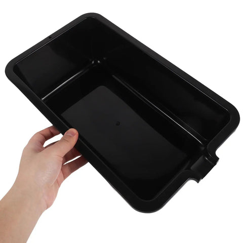 Heavy Duty Portable Oil Catch Pan With Ergonomic Handle For Easy Car Maintenance, features a sturdy black plastic basin held by a hand.
