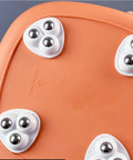 Close-up of 8 Pack Mini Swivel Caster Wheels With Self Adhesive Backing And Triple Ball Bearings on an orange surface.
