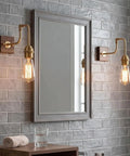 Vintage Brass Wall Sconce, Industrial Wood Light Fixture with adjustable arm beside mirror in modern bathroom setting.