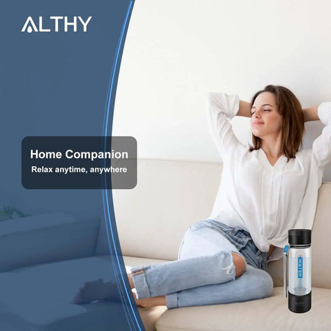Woman relaxing on couch with Hydrogen Water Generator Bottle With Dual Chamber SPE PEM Tech beside her.