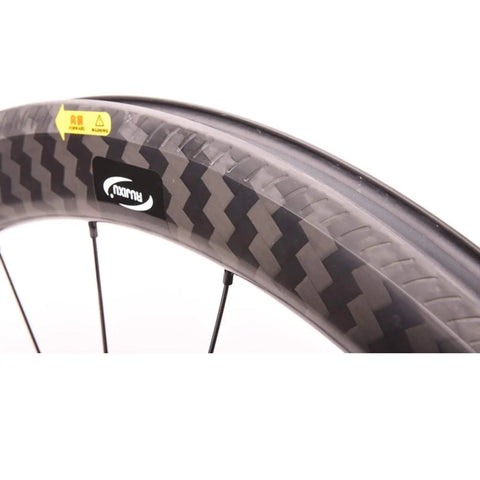 Close-up of Ultra Light 700C Carbon Fiber Road Bike Wheelset with Ceramic Bearings, showing rim detail and quick release hub.