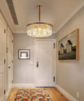 23 Inch 8 Light Modern Crystal Chandelier With Dual Gold Rings hanging in a stylish entryway with artwork and a decorative rug.