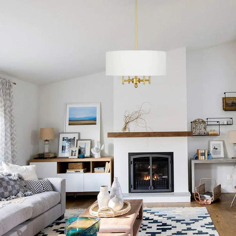 4 Light Gold Modern Drum Chandelier With White Linen Shade 17.7 Inch Pendant Light Fixture in a stylish living room setting