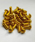 Premium M5 X 10mm Brass Phillips Pan Head Machine Screws scattered on a white surface, fully threaded and corrosion resistant.