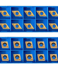 Gold-colored carbide turning inserts CCMT060204 and DCMT070204 in blue plastic organizer boxes, 20 pcs
