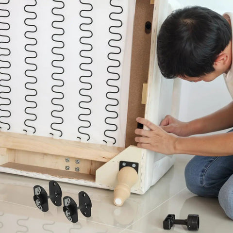 Man installing Heavy Duty Sectional Sofa Connectors Twenty Pack Metal Interlocking Alligator Pins under couch frame.