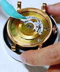 Using Watch Cleaning Putty Kit With Wood Sticks And Adhesive Tack on watch gears, removes fingerprints from pivots and cogs