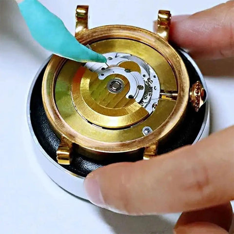 Using Watch Cleaning Putty Kit With Wood Sticks And Adhesive Tack on watch gears, removes fingerprints from pivots and cogs