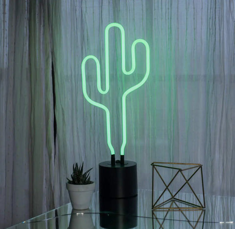 Green Neon Cactus Desk Light That Is Lit For Any Room on glass table with decor items