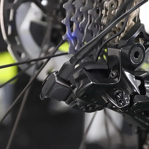 USB C Charging Adapter For Di2 Electronic Derailleurs attached to 12-speed shifting system on a bike, detail view.