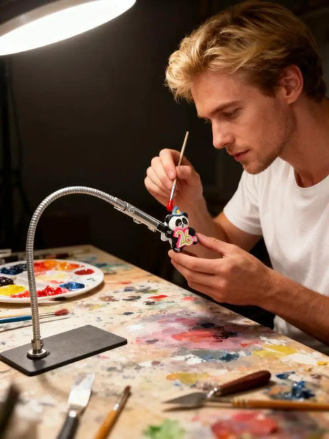 Person using Magnetic Helping Hands Soldering Tool With Flexible Alligator Clip Arms And Magnetic Base for detailed painting project.
