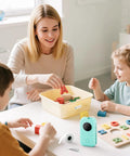 Top Tier Bluetooth Label Maker prints crisp adhesive text instantly while kids play with colorful blocks and letters.