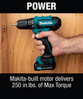 Hand holding 12V Max Cordless Drill Driver Kit With 3/8 In Chuck Two 2Ah Batteries Renewed Variable Speed against wooden board