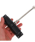 Hand holding automatic door closer with spring hinge for home doors, garden gates, stainless steel tough metal build.