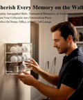 Man mounting 3 Tier Acrylic Golf Ball Display Case With 12 Compartments on wall, showcasing golf ball collection.