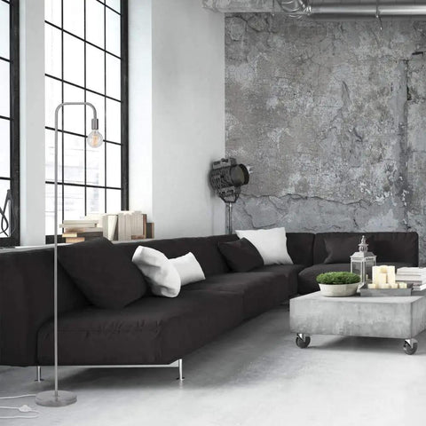 Holden 70 Inch Floor Lamp in Brushed Steel with Inline On Off Foot Switch next to modern black sofa in industrial living room