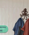 Rad Cast Iron Octopus Wall Hook Rustic Brown Antique Finish holding two towels on a white tiled wall, showcasing sculpted tentacles.
