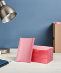 Stack of pink bubble padded mailers self seal envelopes 100 pack for jewelry and makeup supplies waterproof shipping bags