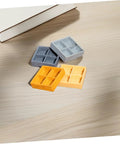Four Grid Dollhouse Storage Box Resin Organizer For Candy, Nuts, And Sweet Tiny Treats in assorted colors on a table