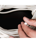 Hand holding Top-Tier Silicone Foam Round Sealing Strip 10M Long, showing flexible cord for heat protection up to 200C.