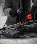Person using Beast 1500A Jump Starter With Air Compressor Portable 12V Car Battery Booster on car engine