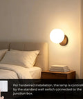 Prosmoon Modern Globe Wall Sconce Set of 2, 3-Color Temperature Adjustable mounted beside a bed with a warm glow.
