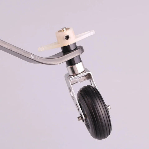 Close-up view of Carbon Fiber Tail Wheel Landing Gear Assembly Kit For Gas Powered RC Airplane With PU Tire Beefed Up Setup For Adults And 26CC Models Durable Replacement Parts For Real World Landings.