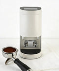 Electric Coffee Tamper With Stainless Steel Dock And Custom Pressure Tuner Yields Tight Espresso Pulls Between Five To Thirty Kilograms with portafilter.