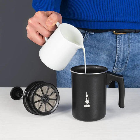Person pouring milk into Tutto Crema Milk Frother Black Barista Grade, 1L Capacity, with double mesh insert on table