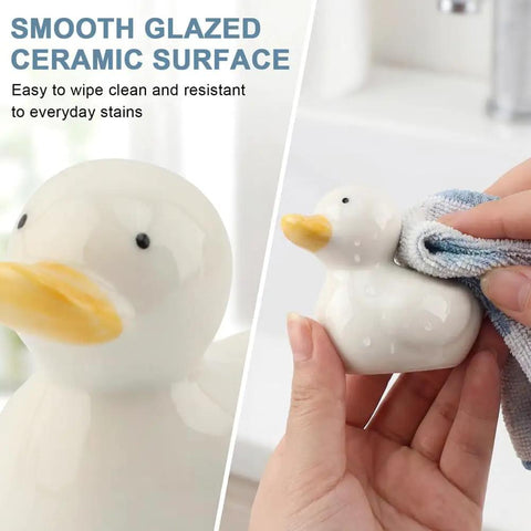 Upgrade Your Lavatory Style With These Dope Duck Toilet Bolt Covers And Slick Ceramic Screw Caps That Hit Different For Instant Bathroom Vibe Quick Install Two Pack For A Crisp Clean Finish. Smooth white ceramic duck being wiped clean.