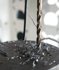 Close-up of a drill bit from the 115 Piece Cobalt Drill Bits Set With High Speed Steel 135 Degree Point Twist drilling metal surface.
