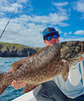 Top Water Co. offshore fishing speed clip bundle on a boat; person holds a large speckled fish.