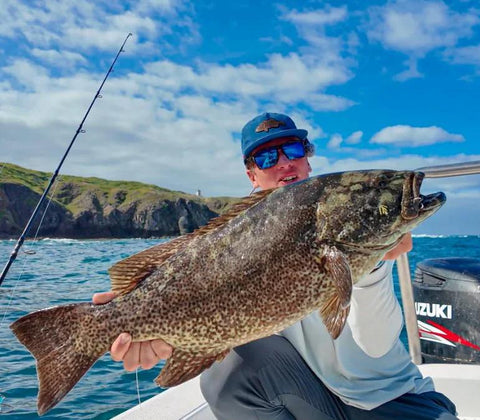 Top Water Co. offshore fishing speed clip bundle on a boat; person holds a large speckled fish.