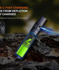 PD36R V2.0 1700 Lumen USB Type C Rechargeable EDC Tactical Flashlight on rock, charging indicator glowing green